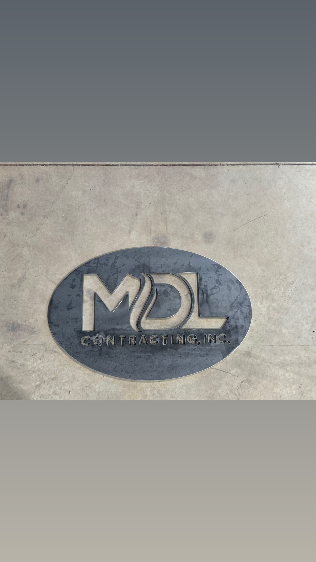 MDL Contracting metal logo sign
